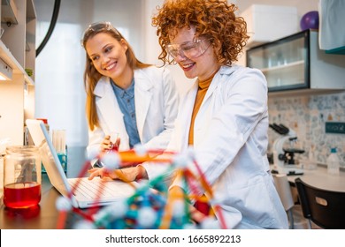 Two young female scientist doing experiments in lab. Scientific research team with clear solution in laboratory. Experienced female scientists is working in laboratory. Doing investigations  - Powered by Shutterstock