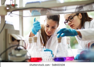 Two young female scientist doing experiments in lab. - Powered by Shutterstock