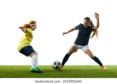 Two young, female soccer players in intense one-on-one moment, both poised to make critical move on green soccer field. Concept of sport, competition, tournament, games, event. - Powered by Shutterstock