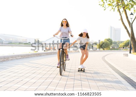 Similar – Happy young people having fun with skateboard and bicycle