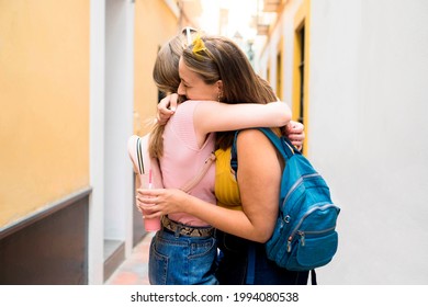 Two Young Girl Friends Hugging Each Other After Meeting Again In A European City During Their Summer Vacation