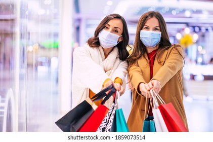 Two Young Girl Friends In Safety Medical Masks During Shopping In The Mall