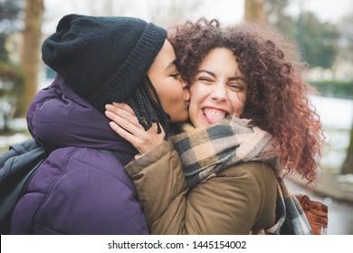 two young girlfriends posing for photo outdoor – friendship, amusement, winter day