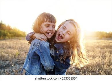 Two Young Girls Have Fun Outside