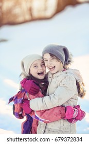 Two Young Girls Laughing On A Winter Day