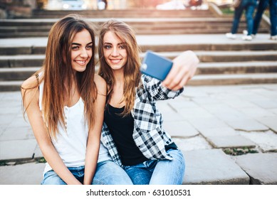 Two young girls making selfie in the park