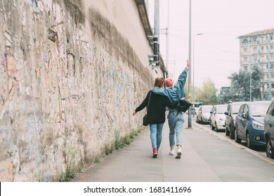 Two young girls outdoor walking hugging - lighthearted, serenity, positivity concept - Shutterstock ID 1681411696