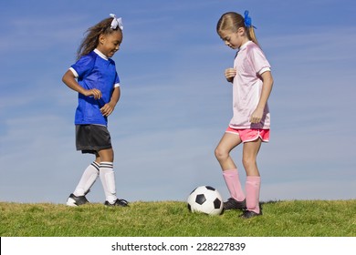 Two Young Girls Playing Soccer (simple Background)