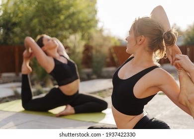 Two Young Girls Practicing Stretching And Yoga Workout Exercise Together