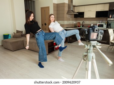 Two Young Girls Recording On Camiera Dance Tutorial For Social Media In The Living Room