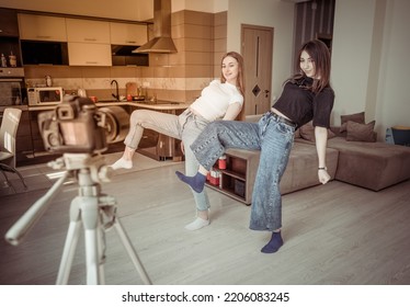 Two Young Girls Recording On Camiera Dance Tutorial For Social Media In The Living Room