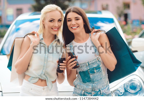 Two\
Young Girls Returned from Shopping with Packages.Leisure Concept.\
Lifestyle Concept. Female in Shopping. Womans with Bags Enjoying in\
Shopping. Consumerism Concept. Cheerful\
Friends.