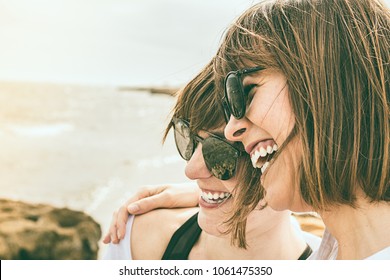 Two Young Girls Smiling By The Sea. Sensation Of Happiness