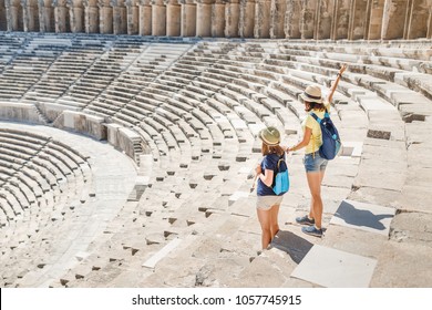 Two Young Girls Student Traveler In The Ancient Amphitheater. Archaelolgy Travel Concept