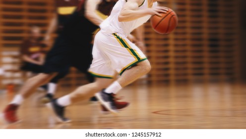 Two Young High School Basketball Players Playing Game. Youth Basketball Players Running in Motion Blur Durning Action. Basketball School Tournament - Powered by Shutterstock