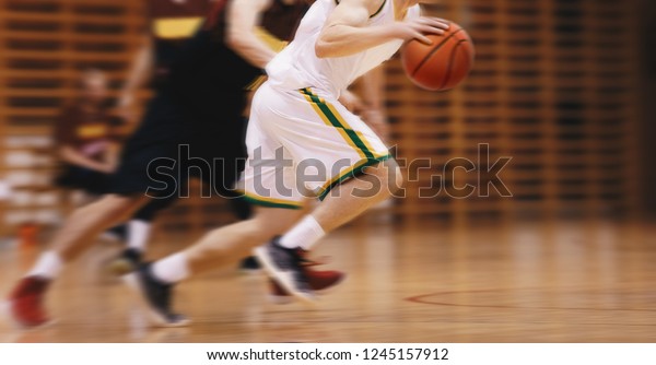 Two Young High School Basketball Players\
Playing Game. Youth Basketball Players Running in Motion Blur\
Durning Action. Basketball School\
Tournament