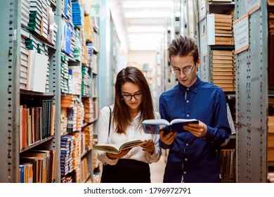 Two Young History Students In Glasses Make A Research In City Archive Database, Looking For The Information For Their Diploma Papers.