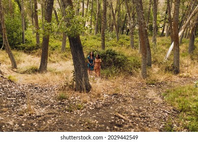 Two Young Lesbians Walking In The Woods Wearing Long Dresses