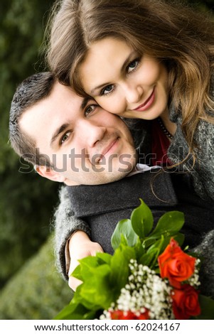 Two young lovers enjoying each other in park