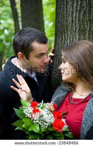 Two young lovers talking to each other in park