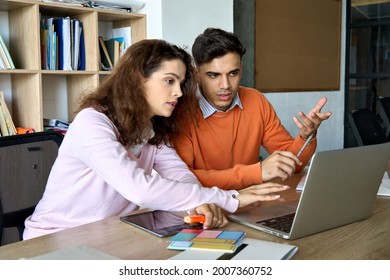 Two young male and female students explaining class work using laptop and tablet device. Multiracial coworkers discussing smart solutions startup business project. Cooperation teamwork concept. - Powered by Shutterstock