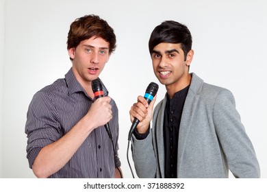 Two Young Male Singers With Microphone In Studio 