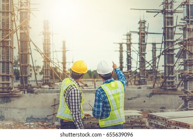 Two young man architect on a building construction site