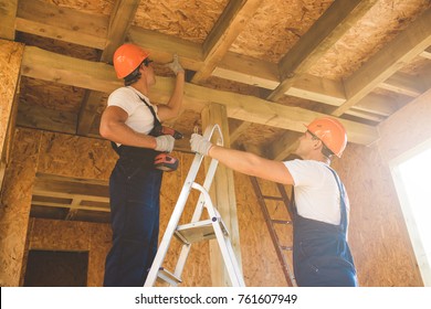 Two young man building wooden house. Ecology concept.