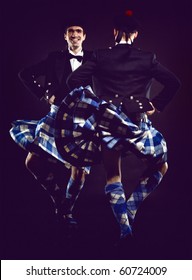 The Two Young Man Dancing The Scottish Dance In A Kilt