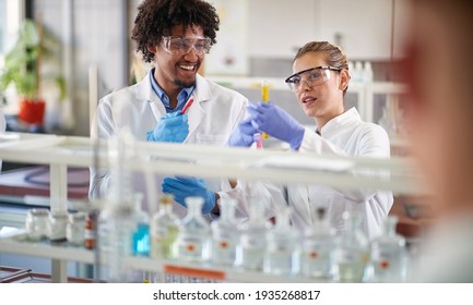 Two young medical students conducting chemical experiment in the lab - Powered by Shutterstock