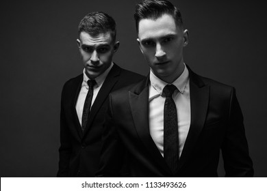 Two Young Men In Elegant Suits Posing. Business Style. Male Beauty, Fashion. Hairstyle.