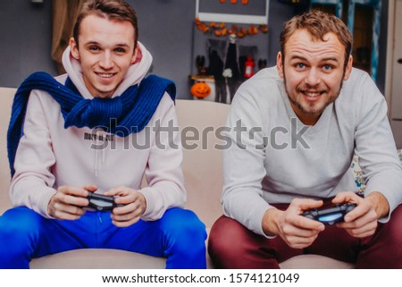 Two young men play virtual games