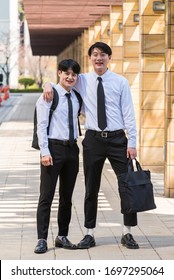 two young men, shoulder-to-shoulder before starting work