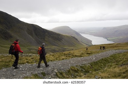 Two Young Men Walking In Lake District, UK