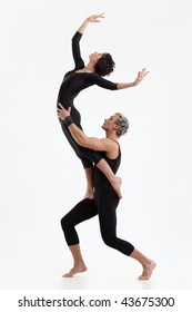 Two Young Modern Acrobats Posing On White