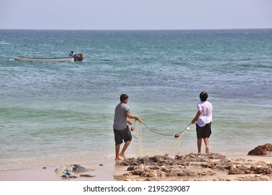 Two Young Omani Kids Fishing At The Shore In Ras Al Hadd In Oman 