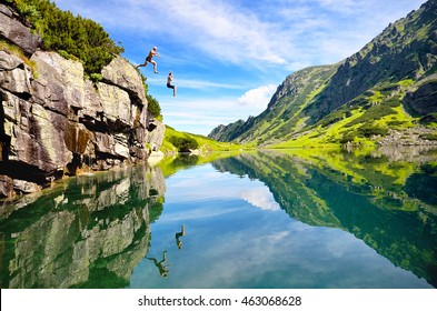 two young people jumping to the water in beautiful mountains nature. Fresh and free scenery from summer vacation - Shutterstock ID 463068628