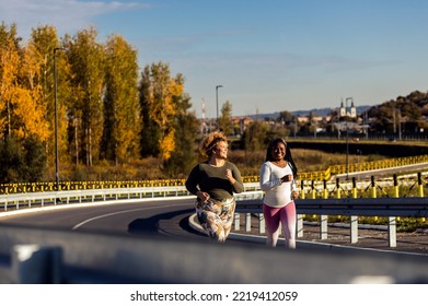 Two Young Plus Size Women Jogging Together.