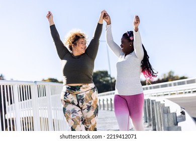 Two Young Plus Size Women Jogging Together.