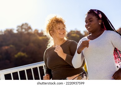 Two Young Plus Size Women Jogging Together.