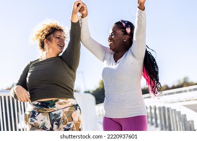 Two Young Plus Size Women Jogging Together.