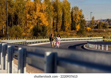 Two Young Plus Size Women Jogging Together.