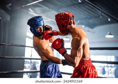 Two young professional boxer having a competition tournament on stage. Attractive male athlete fighters muscular shirtless punches and hitting competitor enjoy boxing exercise in the ring at stadium. - Powered by Shutterstock