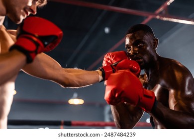 Two young professional boxer having a competition tournament on stage. Attractive male athlete fighters muscular shirtless punches and hitting competitor enjoy boxing exercise in the ring at stadium. - Powered by Shutterstock