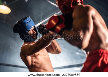 Two young professional boxer having a competition tournament on stage. Attractive male athlete fighters muscular shirtless punches and hitting competitor enjoy boxing exercise in the ring at stadium.