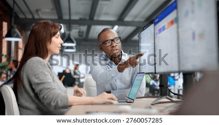 Two Young Professionals Collaborate Using ERP And CRM Software For Business Management, Data Analysis