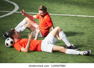 Two young relaxed footballers having talk at break between games of soccer - Powered by Shutterstock