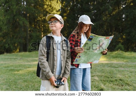Two young scouts are exploring a forest, with a girl reading a map and a boy holding a vintage camera, enjoying their outdoor adventure