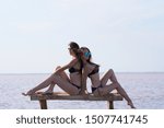 Two young sexy models posing near the water