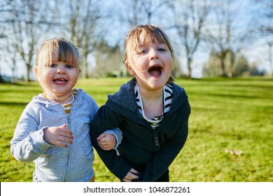 Two Young Sisters Being Silly For Camera